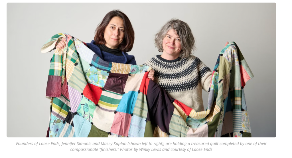 two people holding a quilt